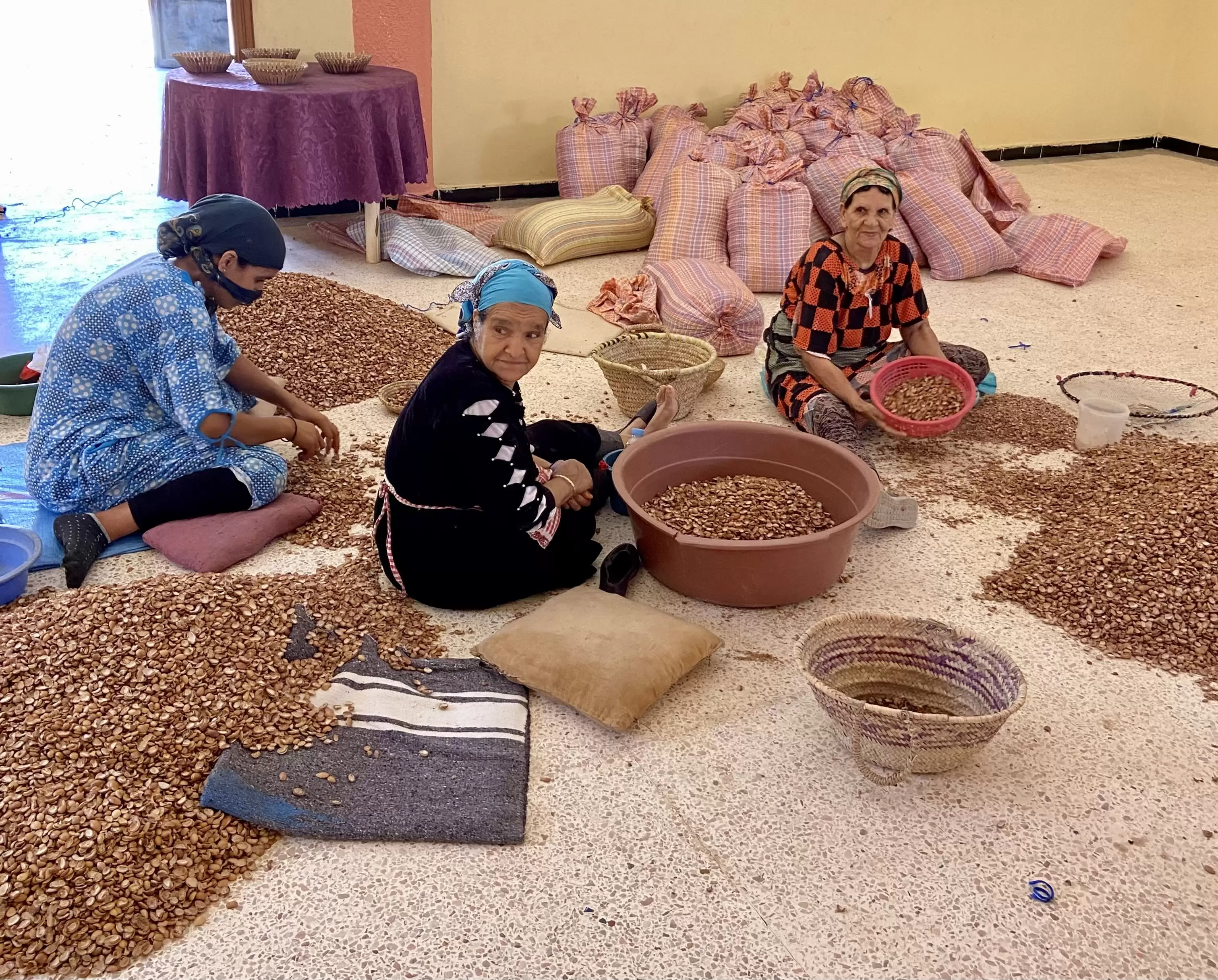Women sieving and separating argan shells